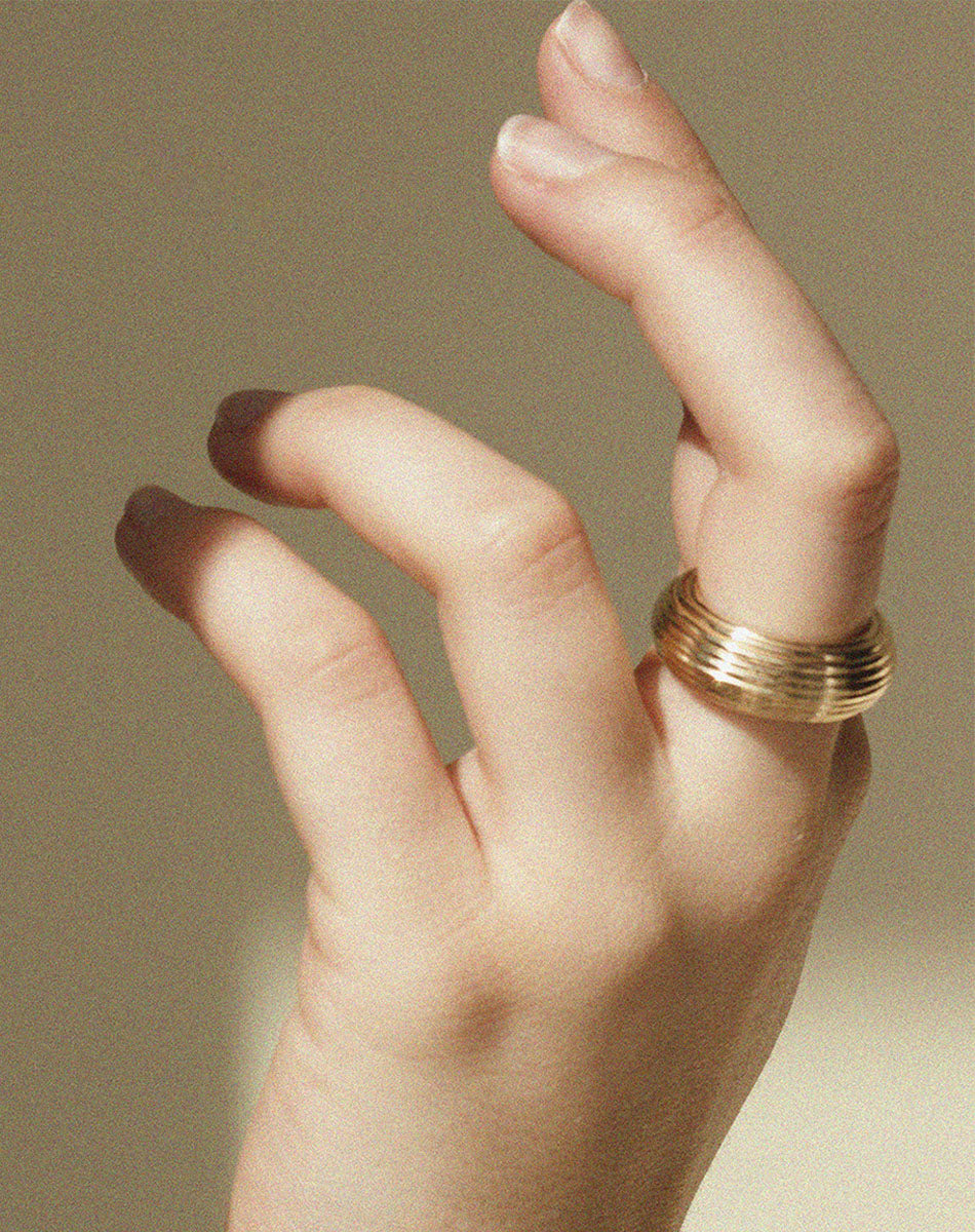 Textured wide band in gold worn by model
