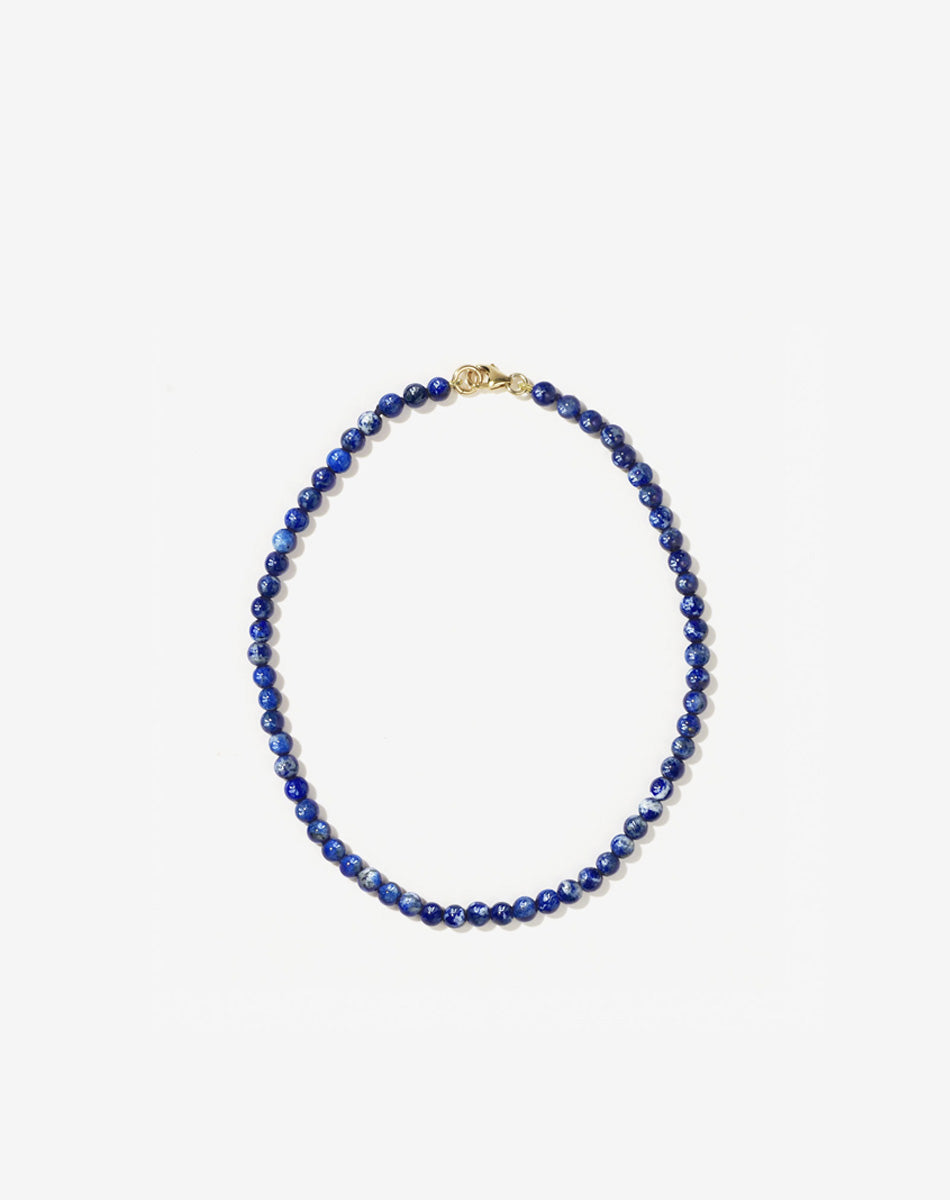 Small spherical lapis lazuli stone beads anklet worn by model